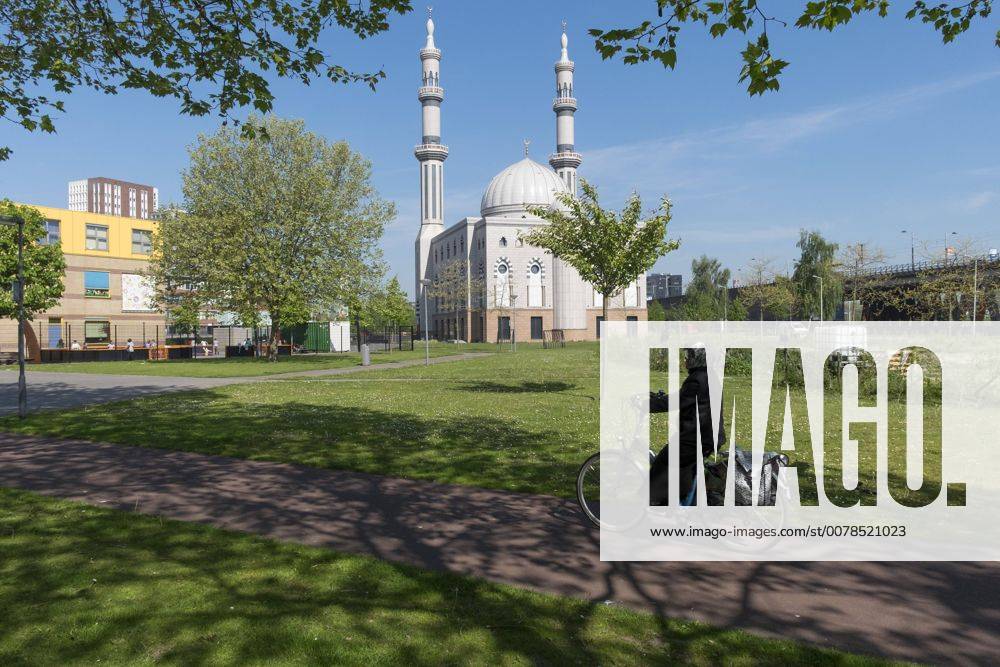 The Netherlands, Rotterdam. A muslimah biking to the Essalam mosque ...