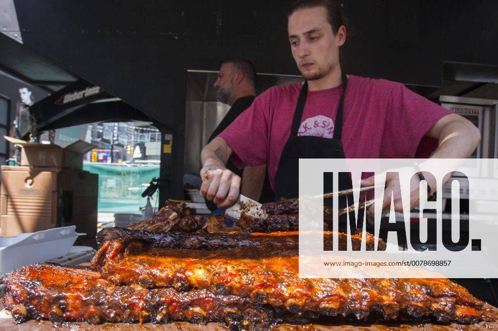 Square One Rib Fest TORONTO, A barbequer cuts ribs during the 2017 Yonge & Dundas Square ...