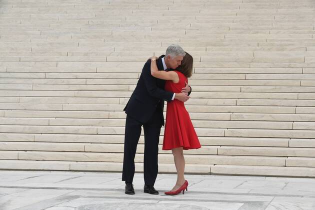 Associate Justice Neil Gorsuch L greets his wife Marie Louise on the steps to the Supreme Court