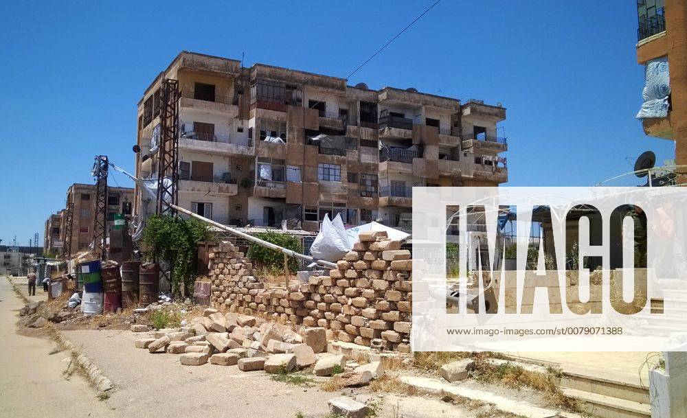 HOMS, SYRIA – JUNE 15, 2017: Damaged buildings in the al-Waer neighbourhood, after rebel fighters