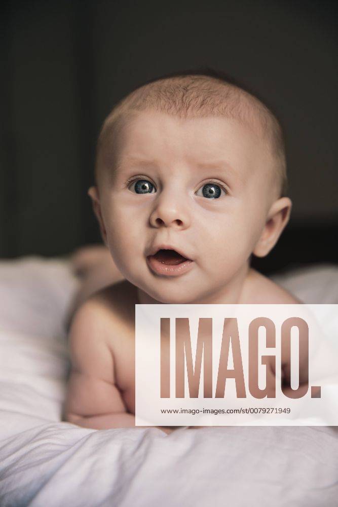 Portrait Of Naked Baby Boy Lying On Bed Portrait Of Naked Baby Boy