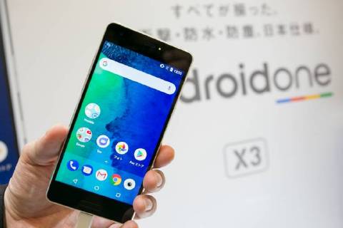 An exhibitor shows a smartphone Android One X2 during a launch event ...