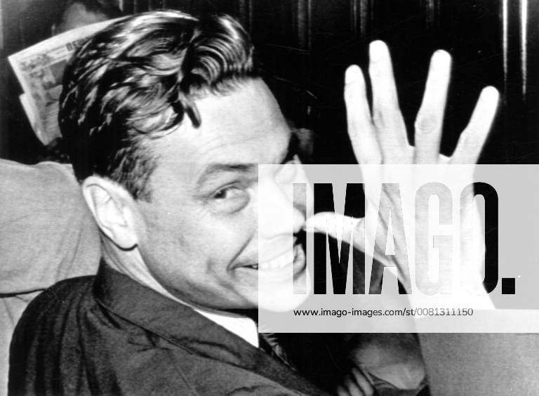 George Lincoln Rockwell thumbs his nose at photographers during a ...