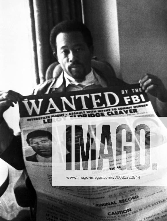 Eldridge Cleaver, holds up his Passport in a Moscow hotel room. The