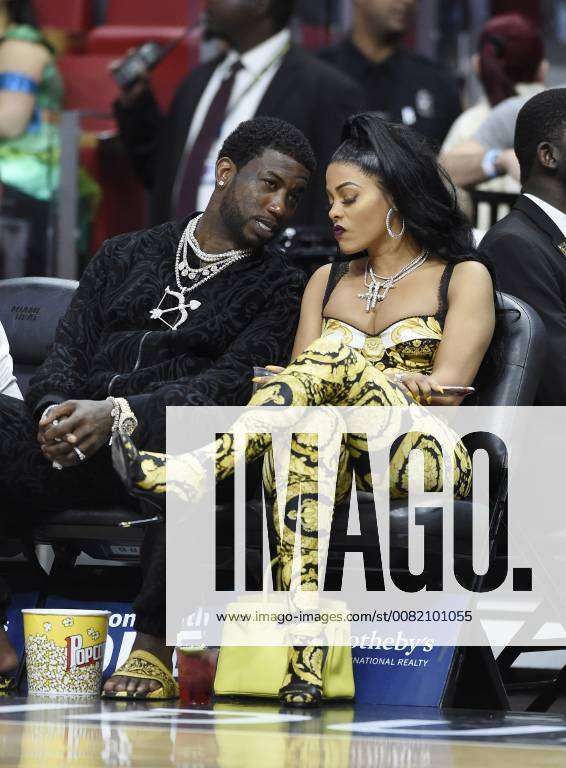 MIAMI, FL - JANUARY 5: Gucci Mane (L) and his wife Keyshia Ka'Oir (R) watch  the Miami Heat against the New York Knicks game at the America Airlines  Arena on January 5