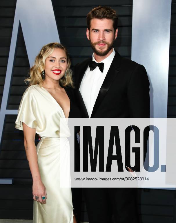 Miley Cyrus and Liam Hemsworth arriving at the Vanity Fair Oscar Party ...