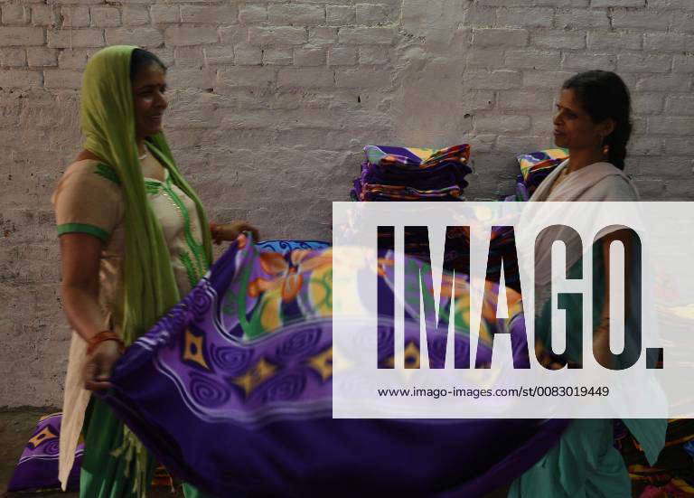 PANIPAT, INDIA APRIL 19 Workers fold fleece blankets at a factory