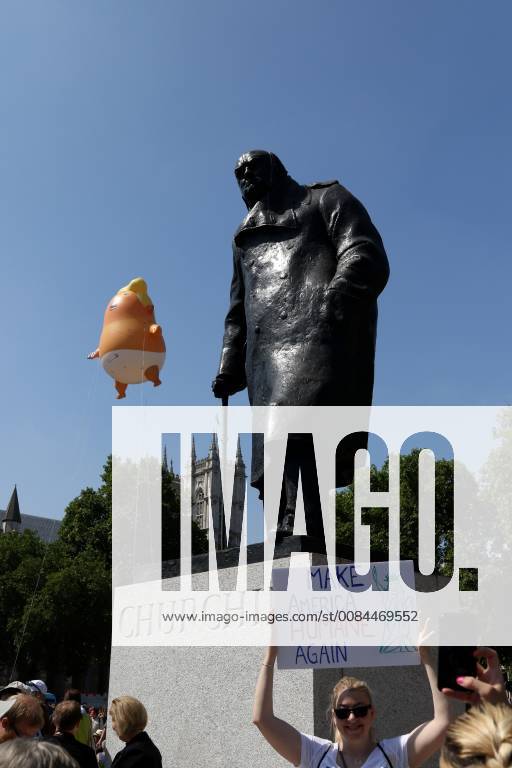 A Donald Trump baby blimp, behind the Winston Churchill statue, flies ...