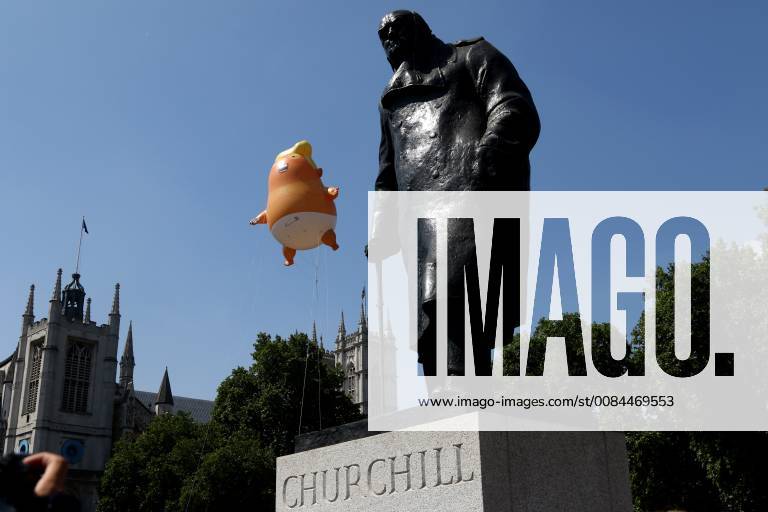 A Donald Trump baby blimp, behind the Winston Churchill statue, flies ...