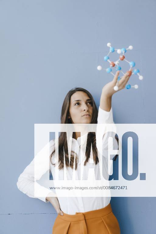 Female Scientist Holding Molecule Model, Looking For Solutions Model ...