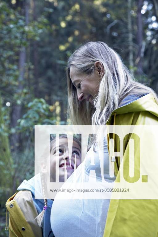 A Pregnant Anya Zuchold And Her Daughter Layla Hug While Walking Through The Woods Near Hamburg 