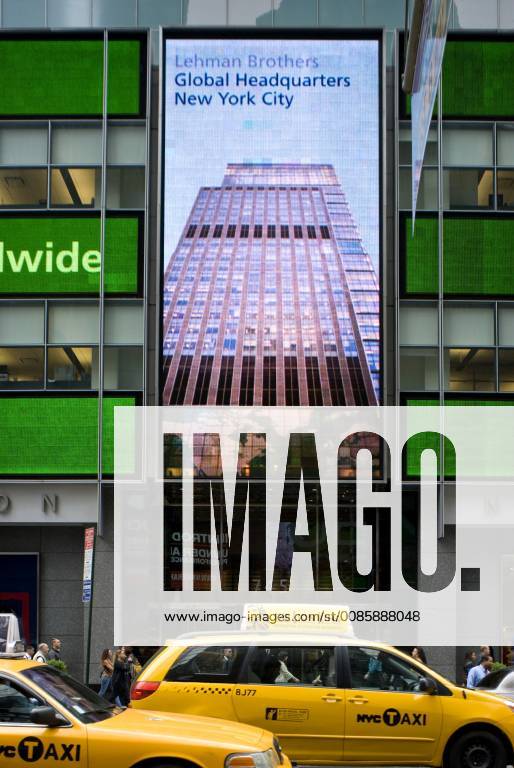 Yellow taxi cabs pass by the banking giant, Lehman Brothers Global