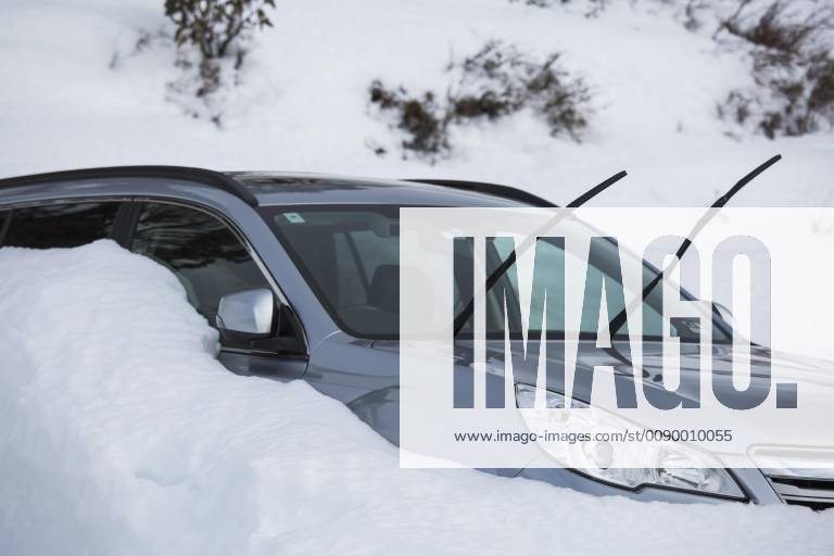 Car parked in snow with windshield wipers up