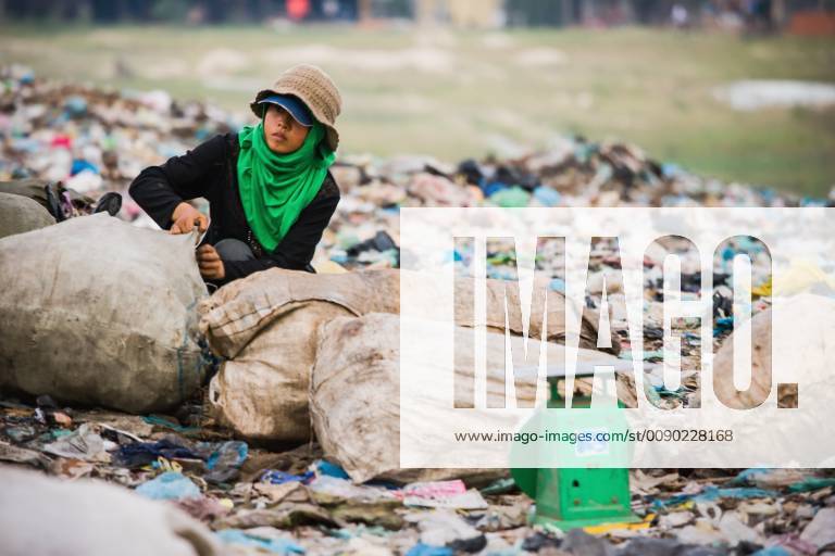 Cambodia, Woman with plastic sacks in city trash dump; Phnom Penh