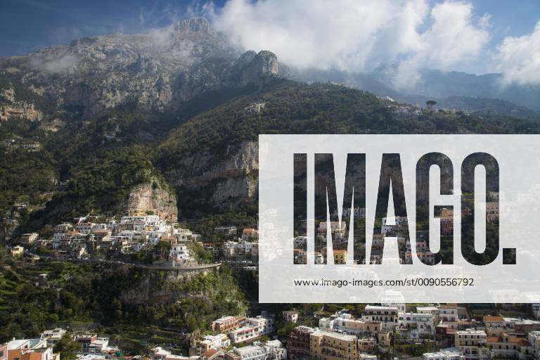 Massive mountains dwarf the town of Positano along the Amalfi Coast ...