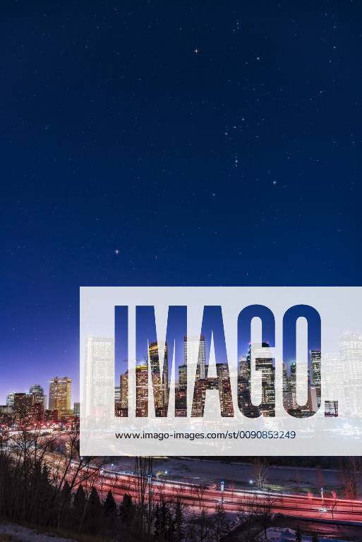 An urban nightscape of the constellations of Orion and Canis Major over ...