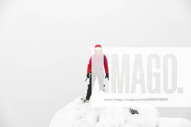 UK, Scotland, Glen Spean, woman on peak of Beinn a Caorainn in winter ...