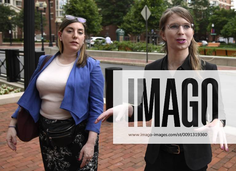Former US Army intelligence analyst Chelsea Manning (R) walks with her