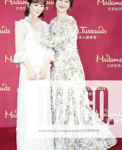 Chinese actress Andy Yang or Yang Zi poses with the wax figure of her ...