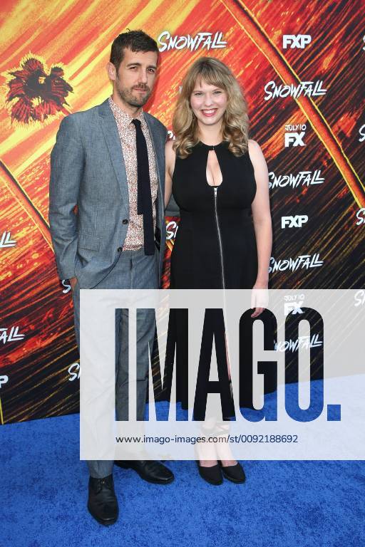 Carter Hudson and his wife Hollye Gilbert taking pictures of the 3 season Snowfall FX series on