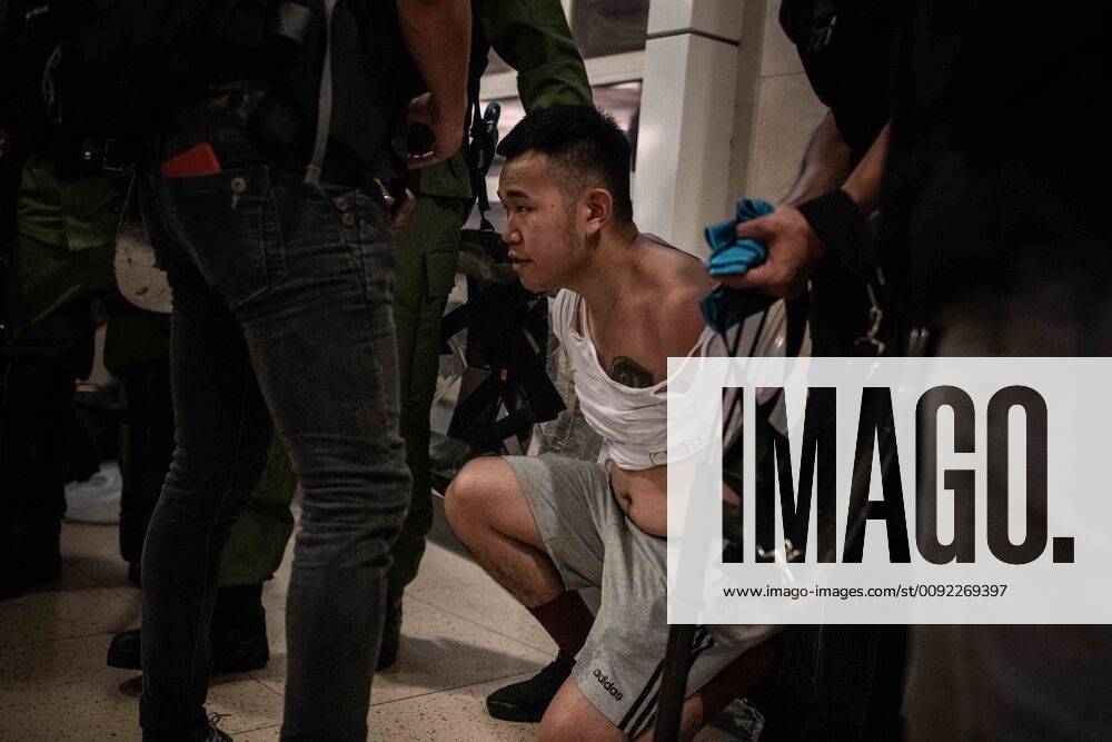 Hong Kong, Hong Kong SAR, China - A man detained by riot police after ...