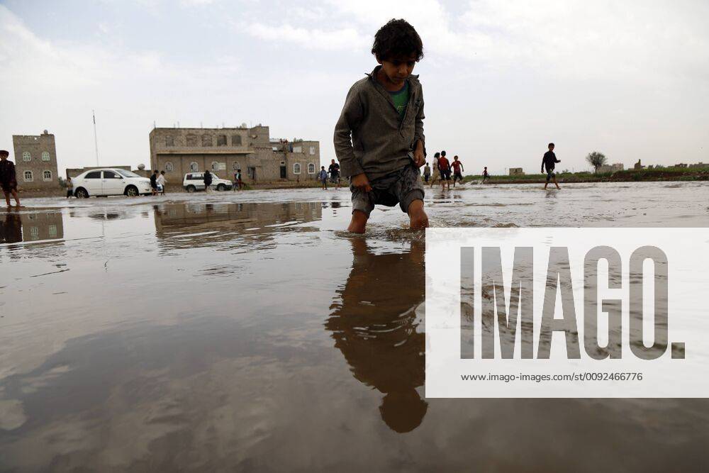 (190727) -- SANAA, July 27, 2019 -- A boy walks in floodwater after ...