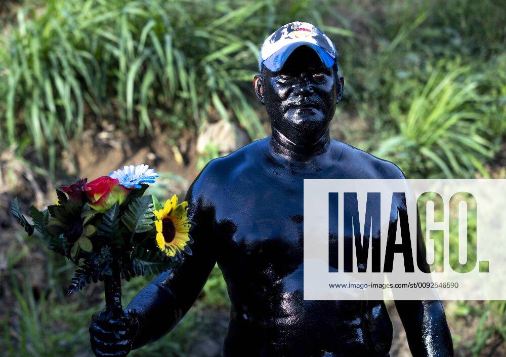 A man covered in burnt oil, the traditional black devil costume