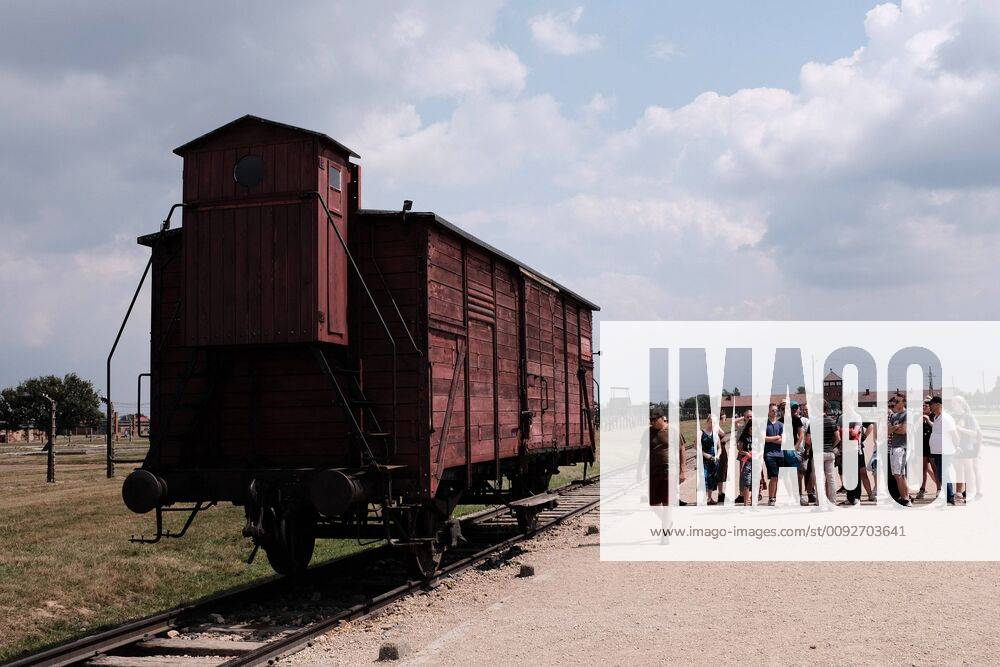 Visitors stand near a German train boxcar that transported Jews to their death in the Nazi Germany