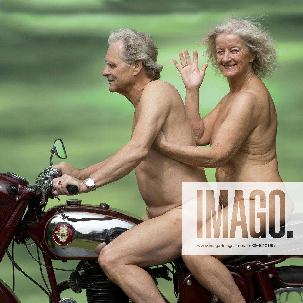 Nude older couple on a motorbike