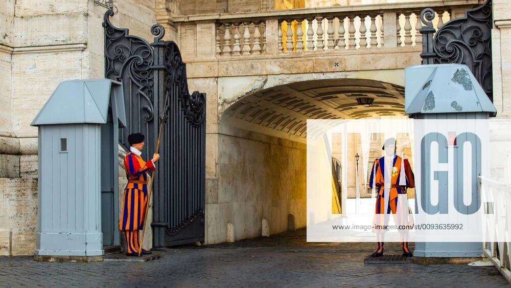 Traditional papal Swiss Guard with halberd in front of a guard house ...