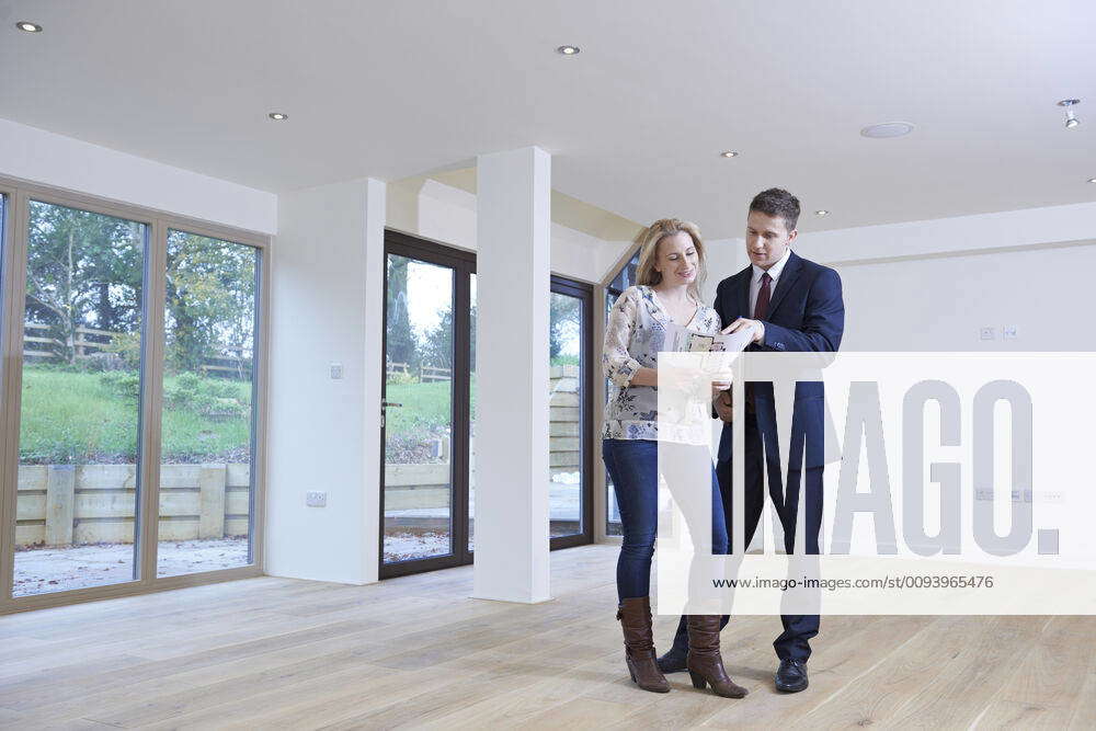 Estate Agent Showing Prospective Female Buyer Around Property,model ...