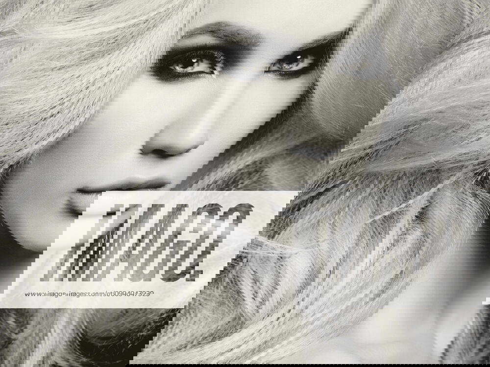 Black and white fashion studio photo of beautiful blonde woman with smoky eyes makeup,model