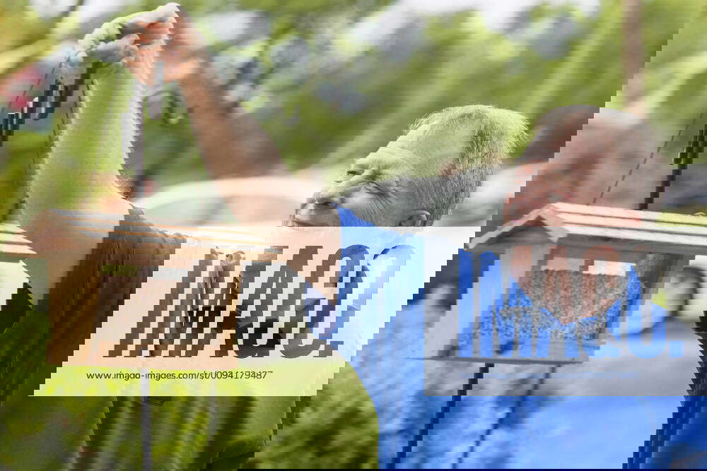 Man with Cerebral Palsy and dyslexia putting out bird food