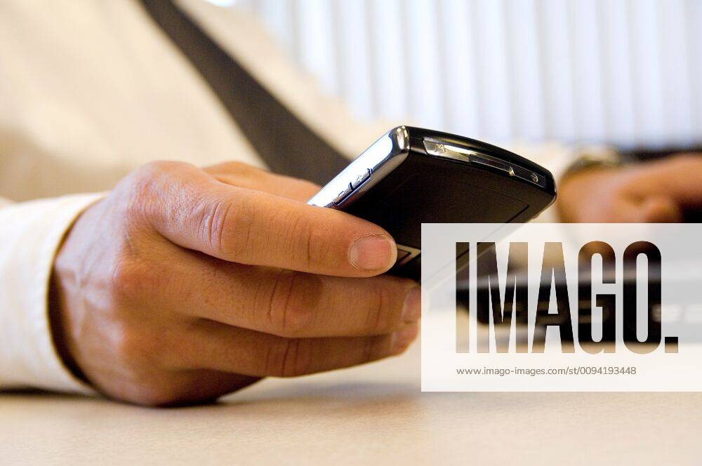 Closeup of male hand holding PDA device