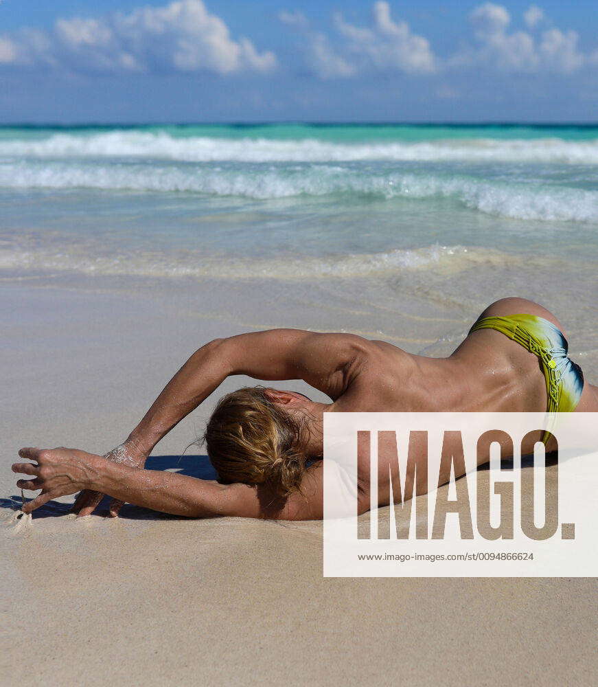 Topless Woman laying on beach from behind Tulum, Mexico