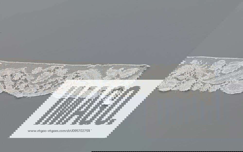 Strip of bobbin lace with a wavy band of lancet leaves and all kinds of