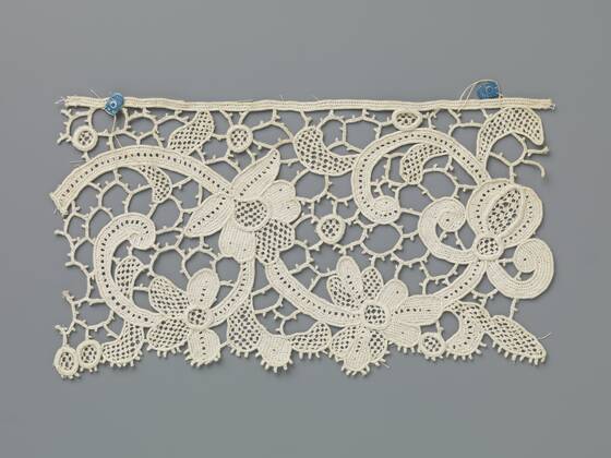 Strip of needle lace with two curling tendrils and