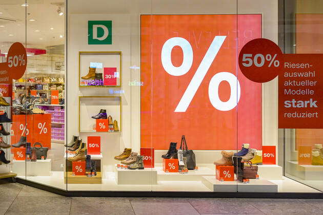 Shop window with oversized percent sign Dosenbach shoes 50 Mall