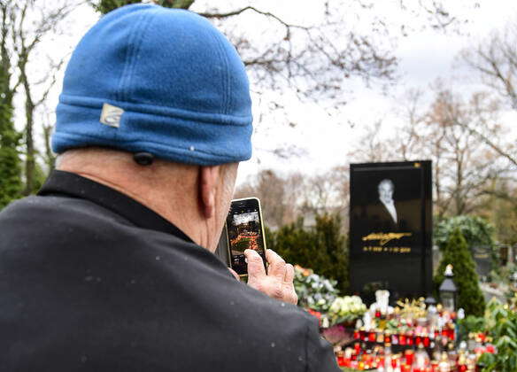 People lit candles at the grave of late Czech pop star Karel Gott, who ...