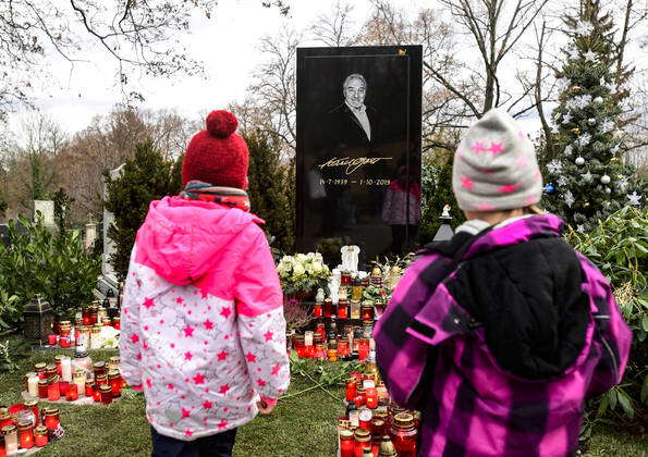 People lit candles at the grave of late Czech pop star Karel Gott, who ...