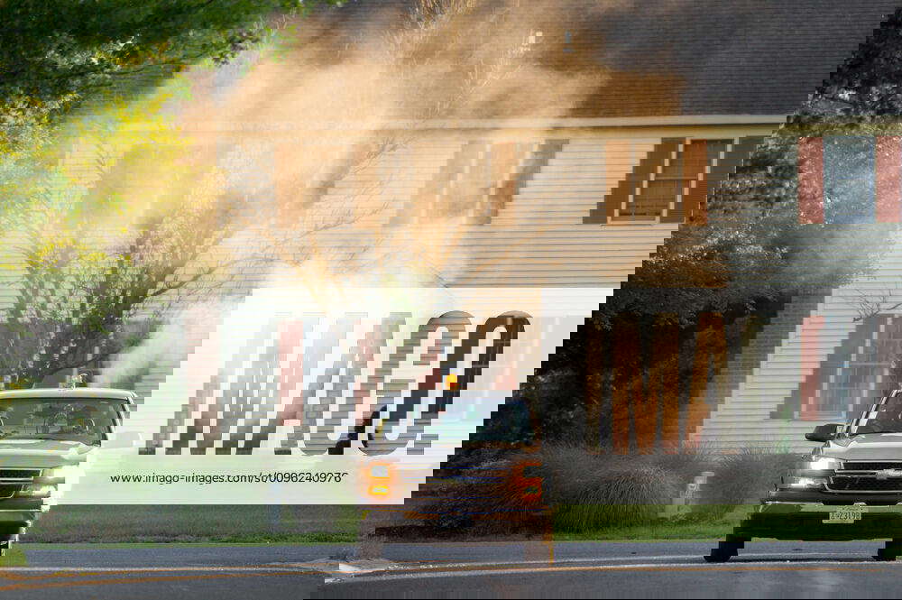 Mosquito Control Truck drives through suburban neighborhood spraying