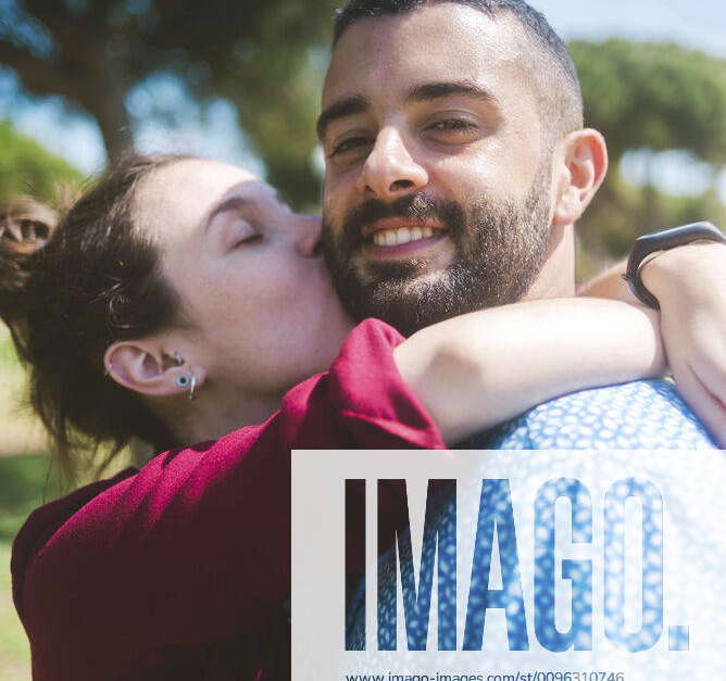 happy-couple-kissing-and-hugging-in-the-park-barcelona-spain