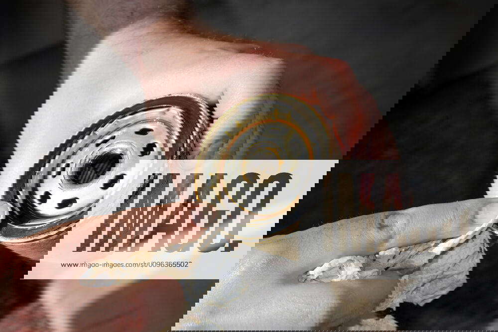 Dirty Used Oil Filter A backyard mechanic wipes the seal of a slightly