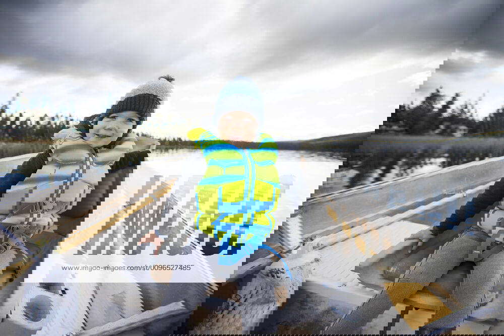 Young boy sitting in aluminum boat during fishing trip. Lac Le Jeune