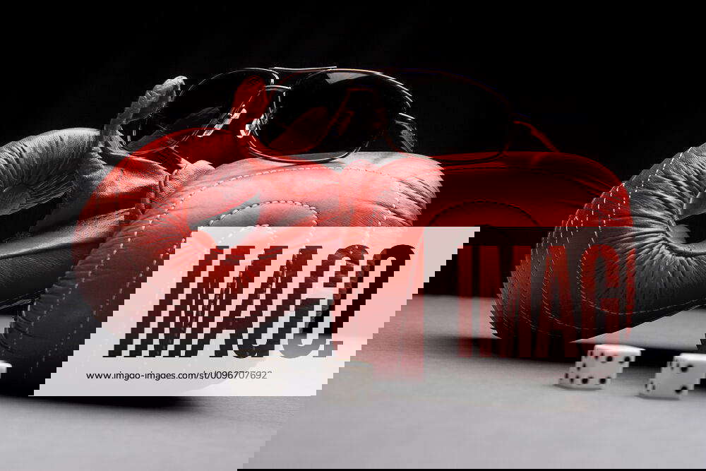 Fight and gambling Men s sunglasses place on top of boxing gloves with