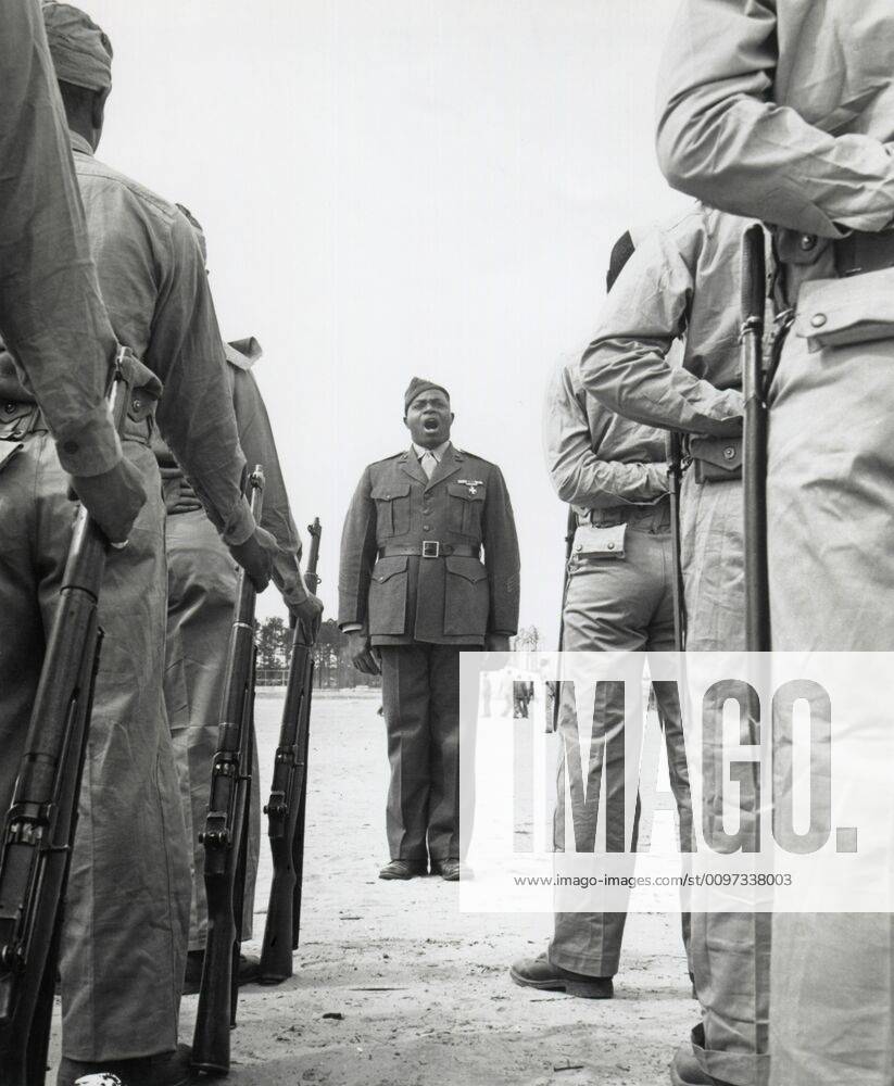African American Marine boot recruits listen to their drill instructor ...
