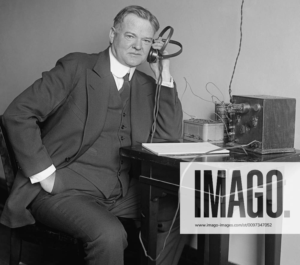 Herbert Hoover, Secretary of Commerce, listening to a radio on Dec. 31 ...