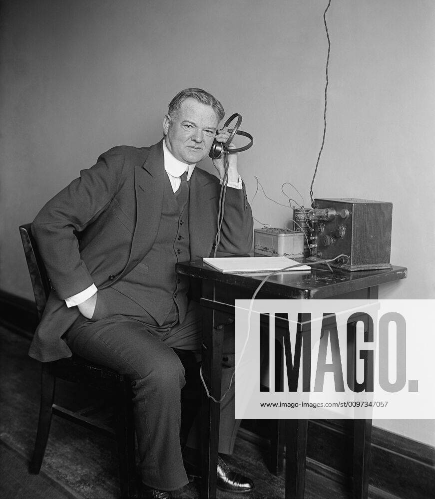 Herbert Hoover, Secretary of Commerce, listening to a radio on Dec. 31 ...