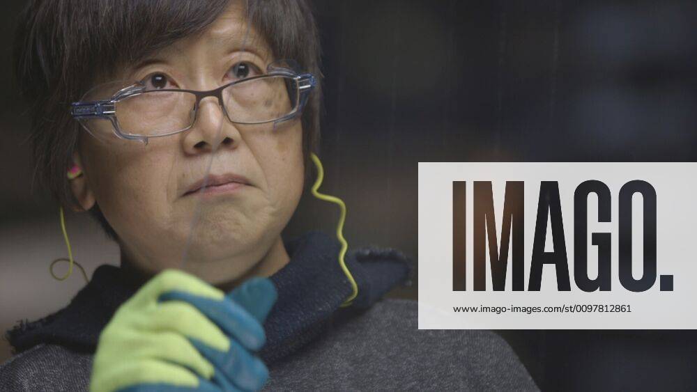 AMERICAN FACTORY, HuiMei inspecting glass in the Fuyao factory in