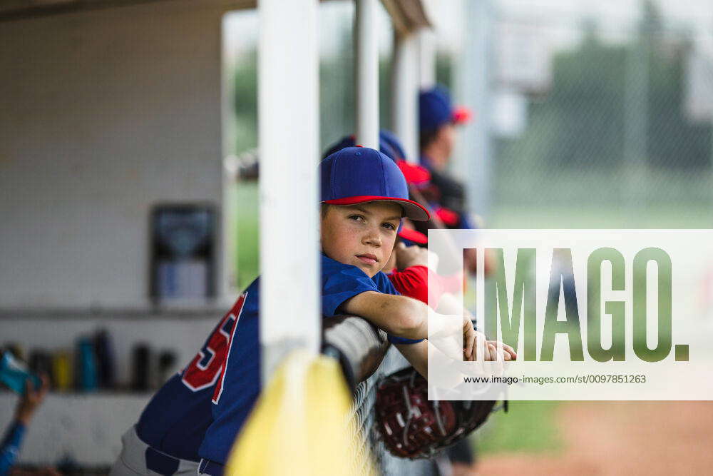 Boy in dugout during little league baseball game Canada, Alberta ...